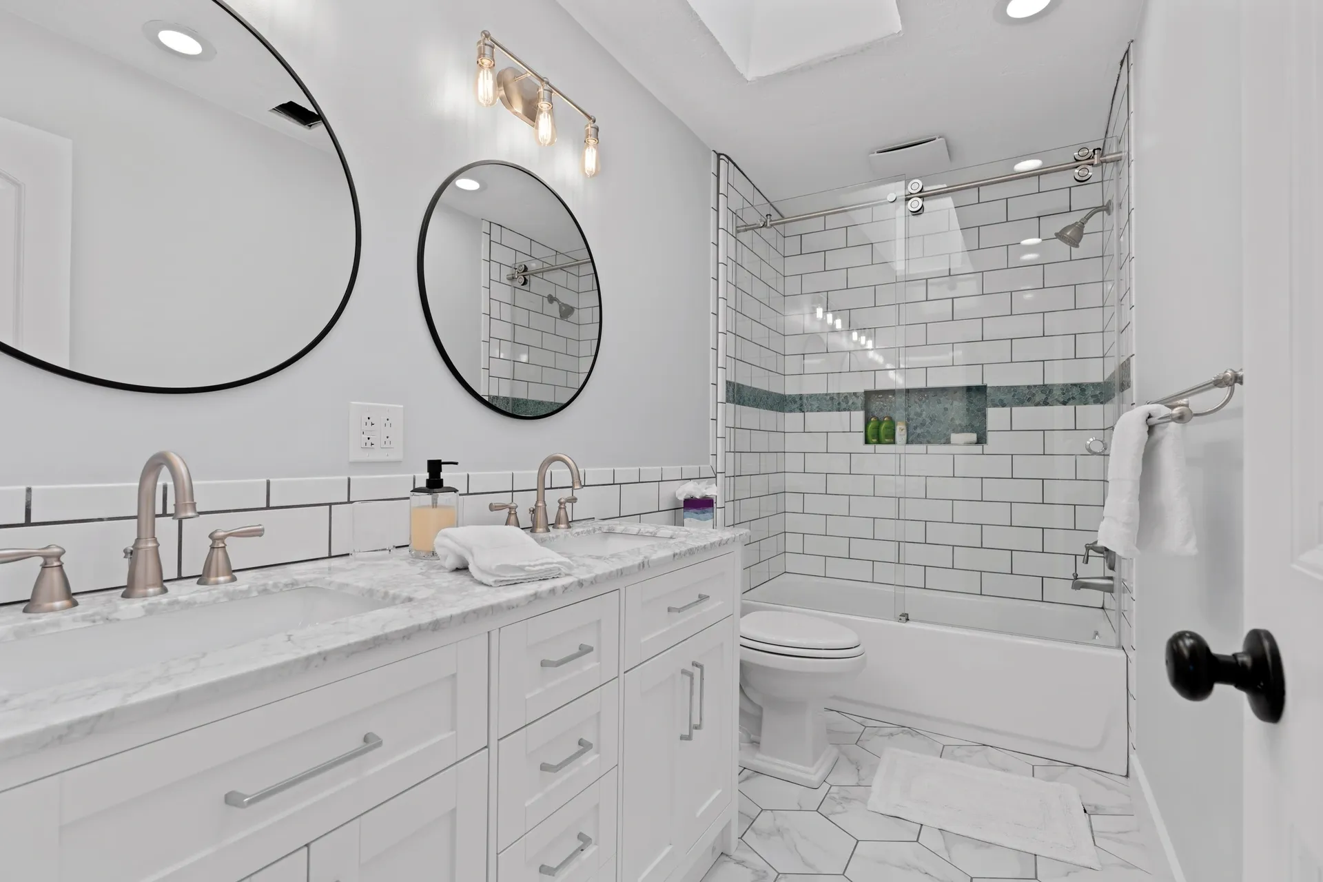 Spacious bathroom featuring double sinks